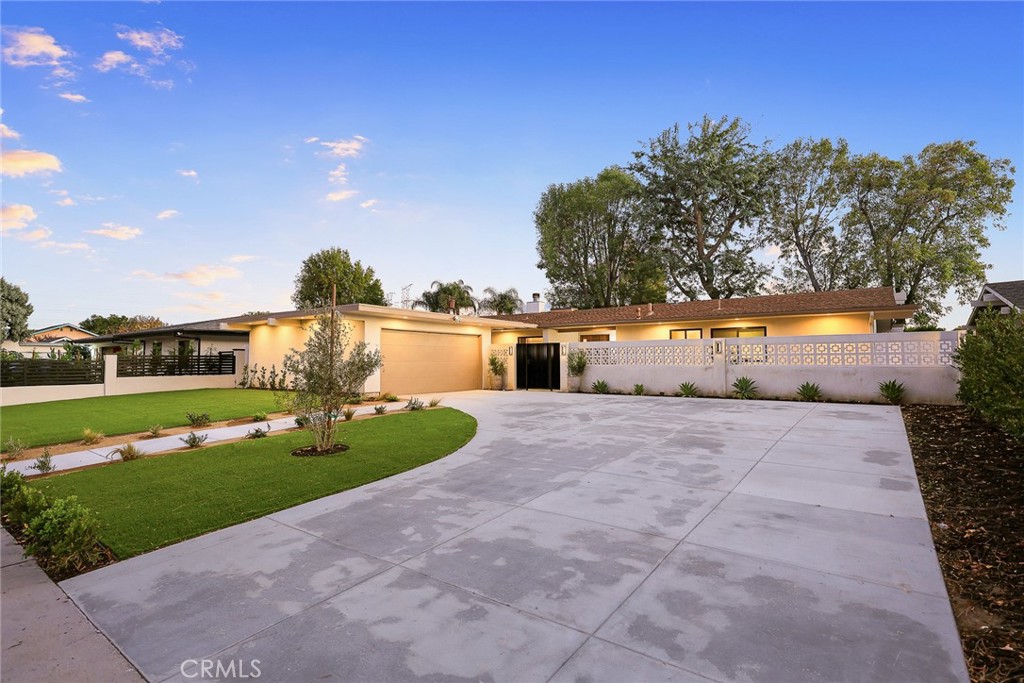 18234 Tribune Street Porter Ranch, CA 91326 - Photo 2 of 26 a front view of a house with a yard and mountain view