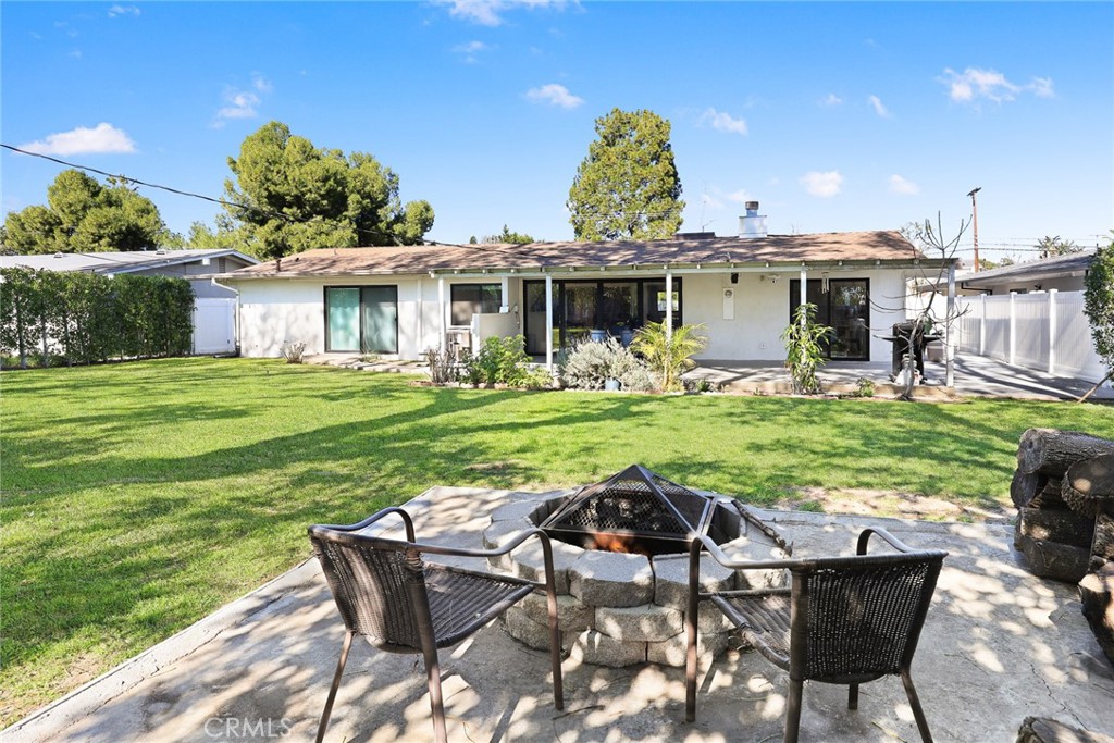 18234 Tribune Street Porter Ranch, CA 91326 - Photo 21 of 26 a view of a house with backyard sitting area and garden