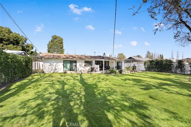 a view of a house with a backyard