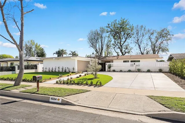 a view of a hallway with potted plants
