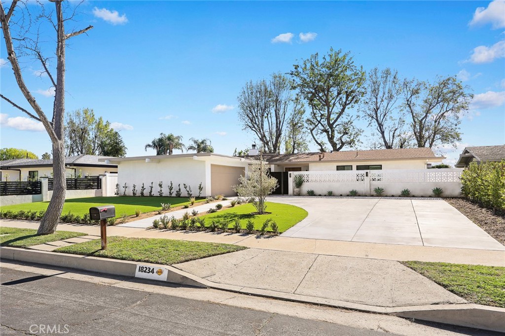 18234 Tribune Street Porter Ranch, CA 91326 - Photo 3 of 26 a view of a patio with table and chairs under an umbrella
