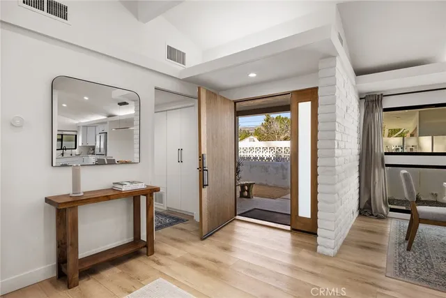 a living room with furniture large window and a fireplace
