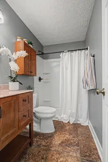 a bathroom with a toilet sink and shower
