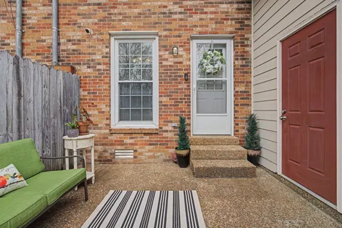 a view of house with entryway and wooden walls