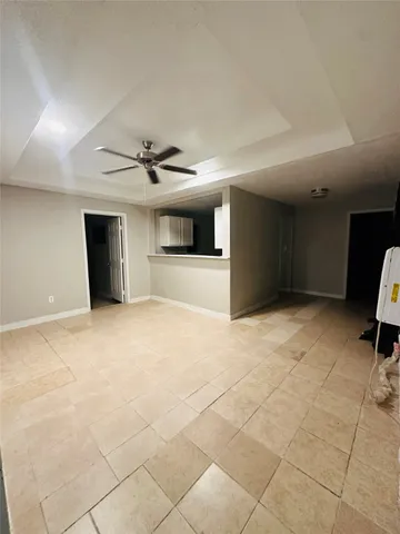 a view of a livingroom with a ceiling fan and window