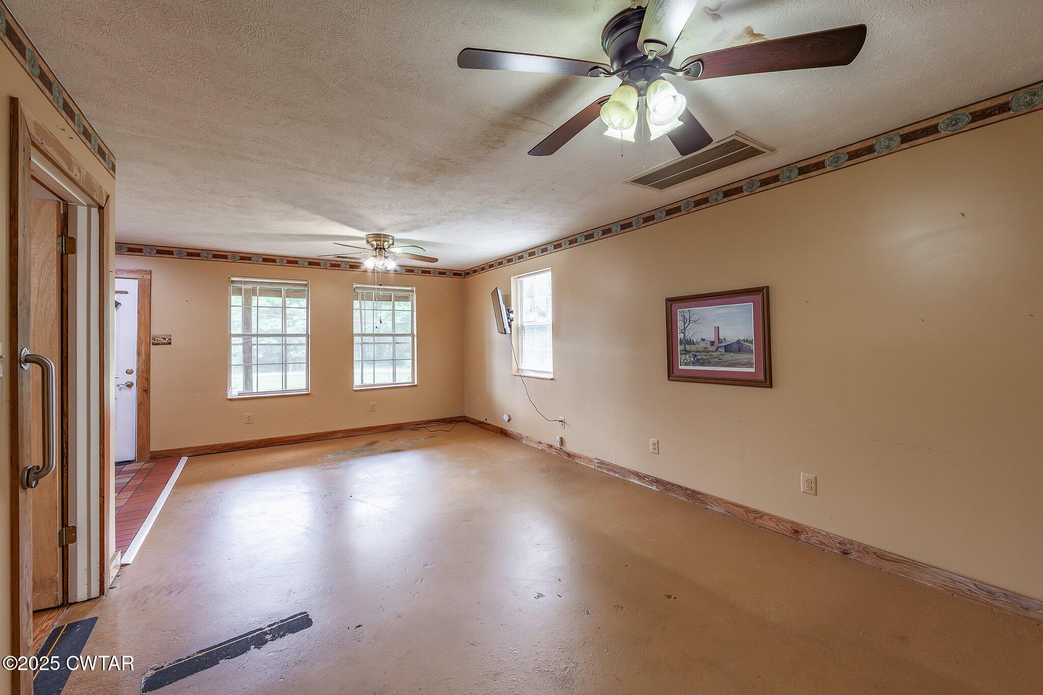1276 Mifflin Road Jackson, TN 38301 - Photo 14 of 35 a view of an empty room with window and wooden floor