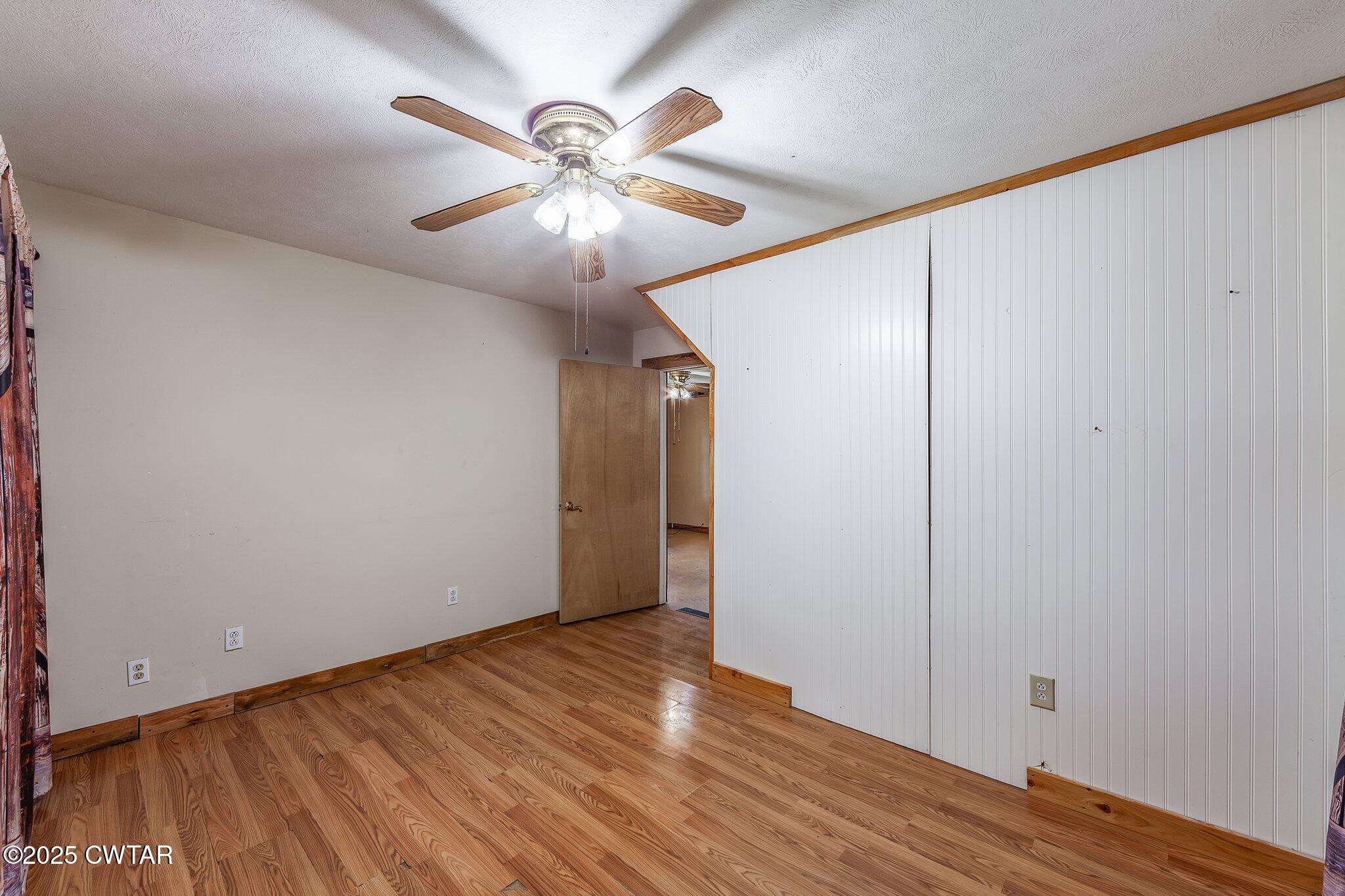 1276 Mifflin Road Jackson, TN 38301 - Photo 17 of 35 an empty room with wooden floor and windows