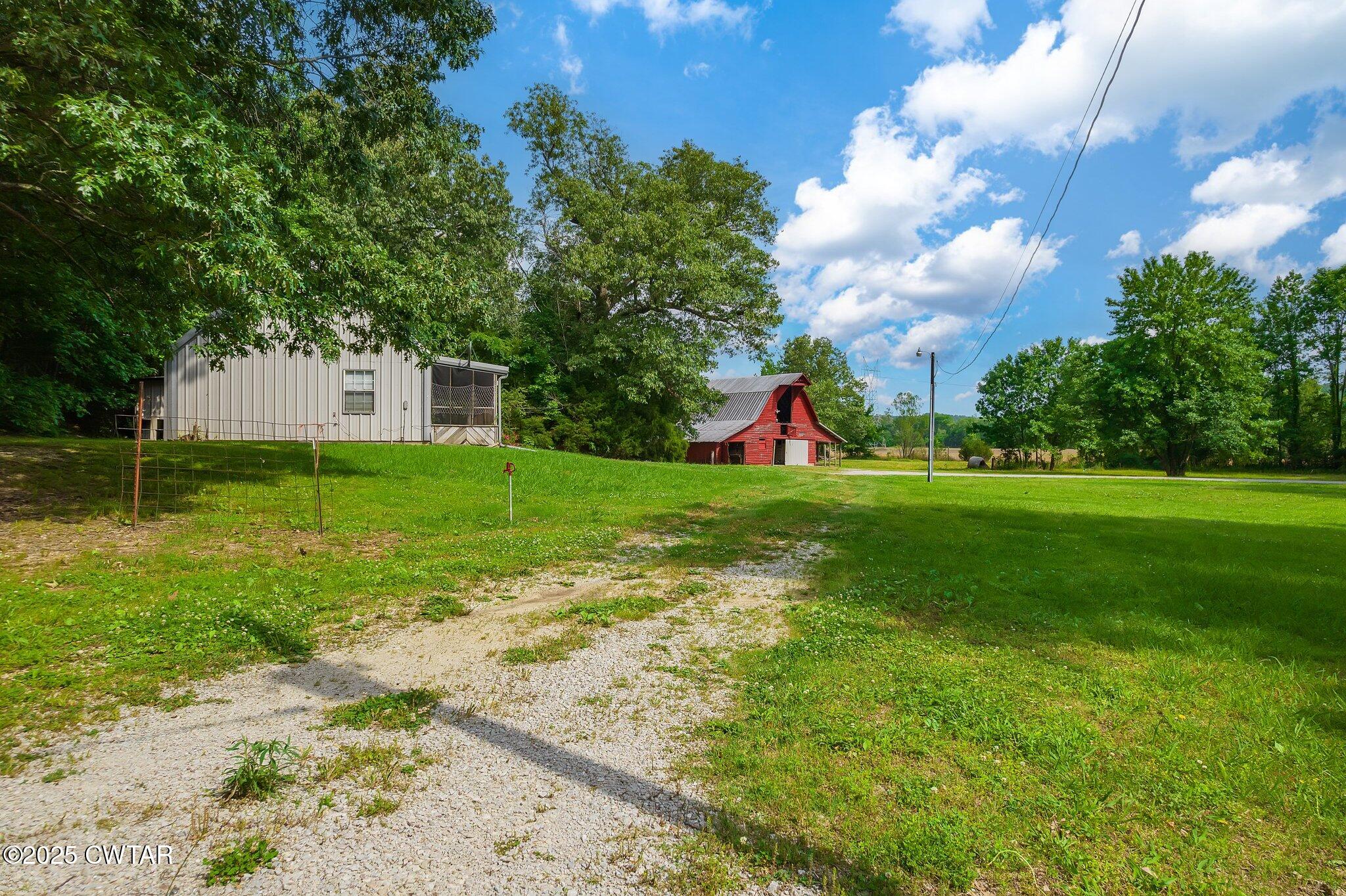 1276 Mifflin Road Jackson, TN 38301 - Photo 27 of 35 a view of yard with swimming pool and green space