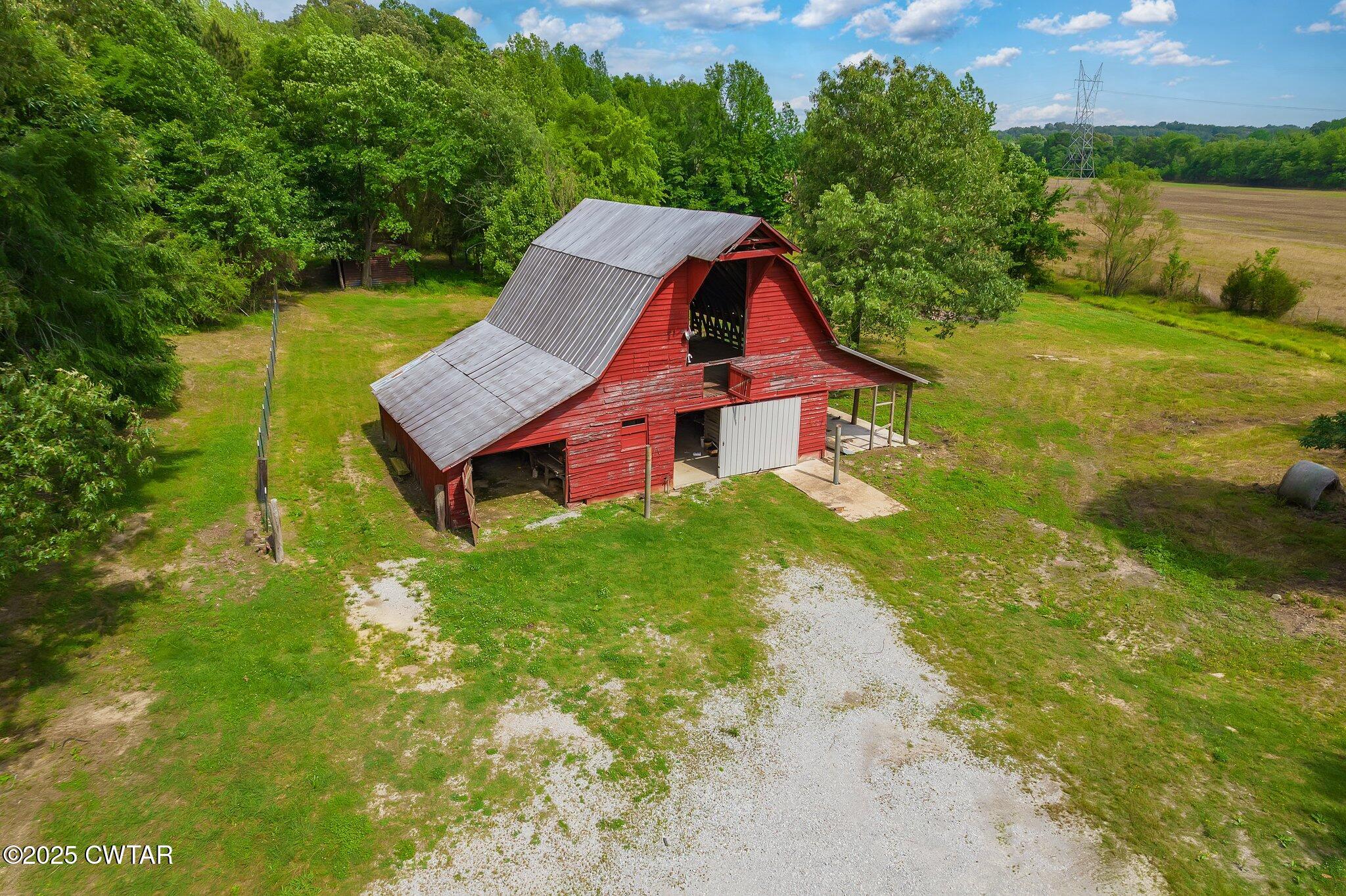1276 Mifflin Road Jackson, TN 38301 - Photo 29 of 35 an aerial view of a house with swimming pool garden view and trees
