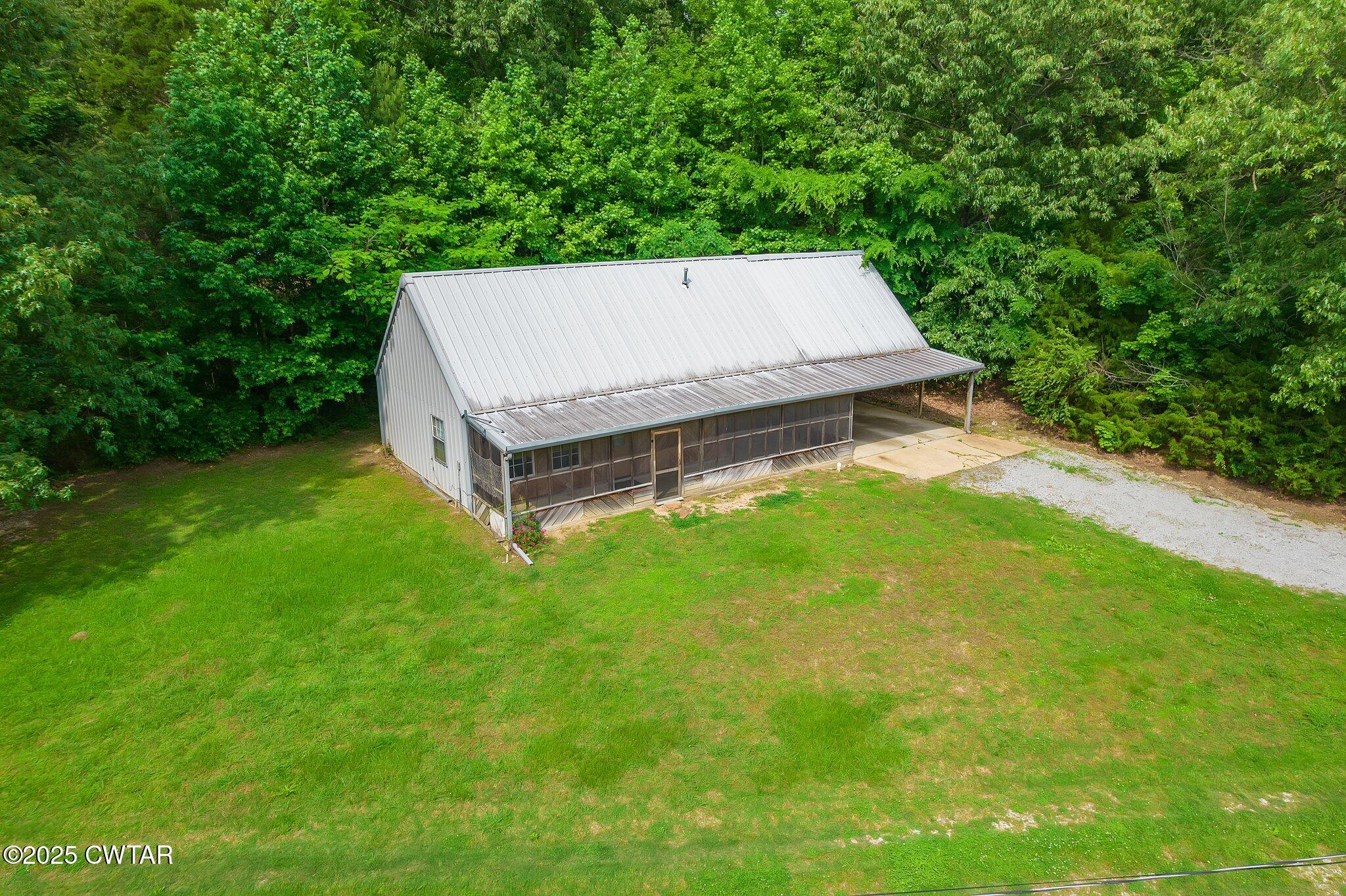 1276 Mifflin Road Jackson, TN 38301 - Photo 3 of 35 a view of a backyard with a small cabin
