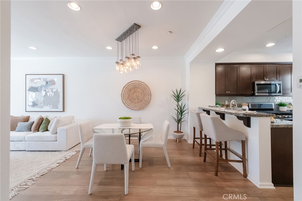 5341 Strand, Unit 105 Hawthorne, CA 90250 - Photo 13 of 67 a view of a dining room with furniture and wooden floor