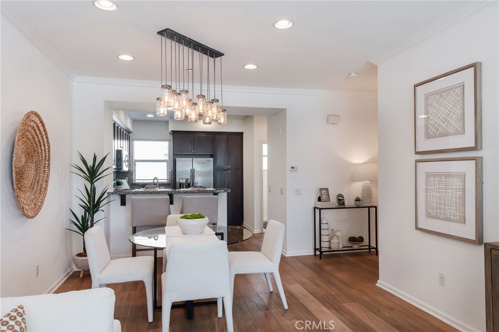 5341 Strand, Unit 105 Hawthorne, CA 90250 - Photo 14 of 67 a view of a dining room with furniture a chandelier and wooden floor