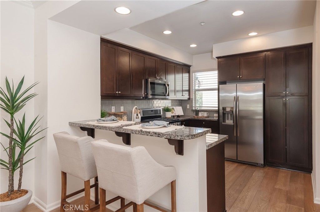 5341 Strand, Unit 105 Hawthorne, CA 90250 - Photo 15 of 67 a kitchen with kitchen island a sink stove and refrigerator