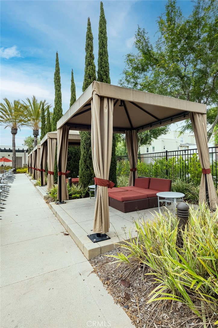 5341 Strand, Unit 105 Hawthorne, CA 90250 - Photo 49 of 67 a view of a patio with a table chairs potted plants and a palm tree