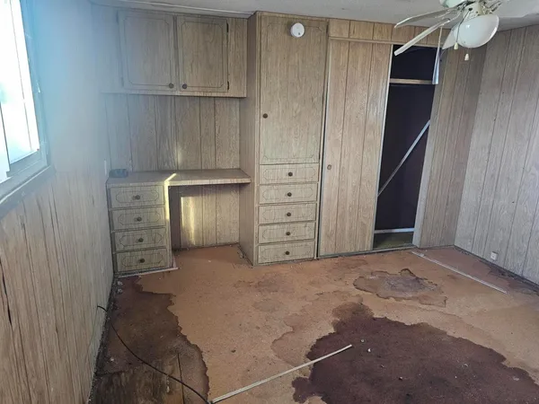 a view of a closet with wooden floor and a cabinet