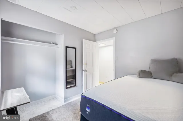 a bedroom with a bed and a chair