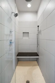 a bathroom with a bathtub and shower