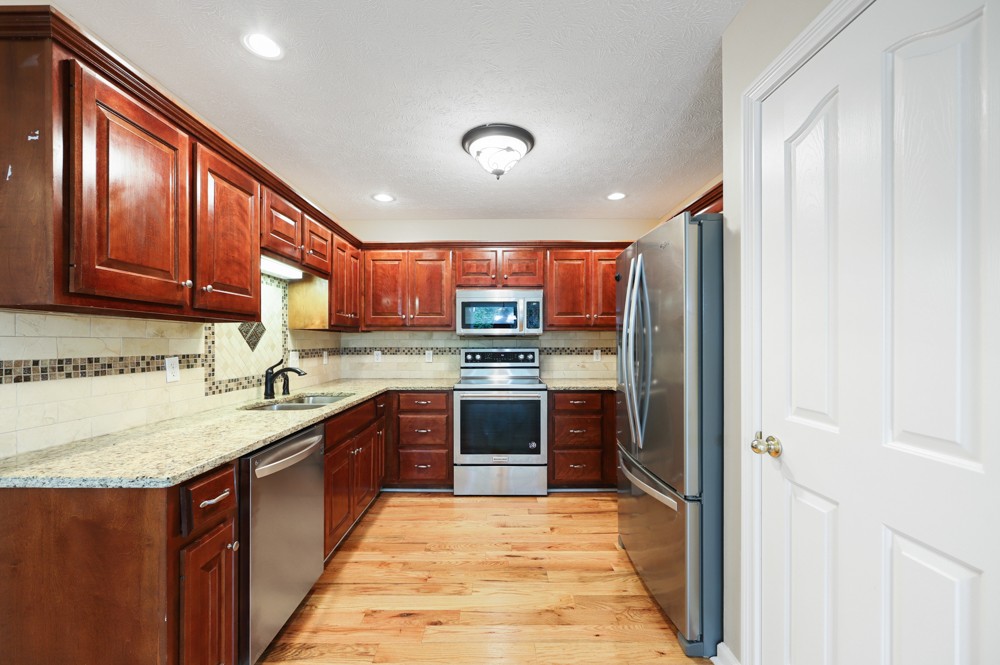 323 Independence Street Springfield, TN 37172 - Photo 12 of 37 a large kitchen with stainless steel appliances granite countertop a refrigerator and a sink