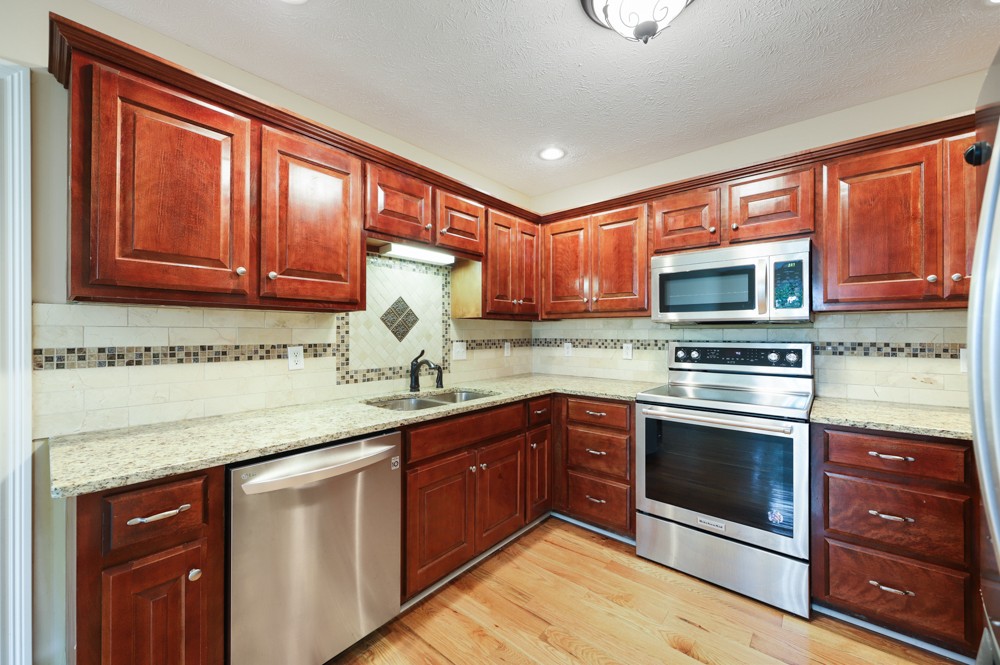 323 Independence Street Springfield, TN 37172 - Photo 14 of 37 a kitchen with stainless steel appliances granite countertop a stove sink and microwave