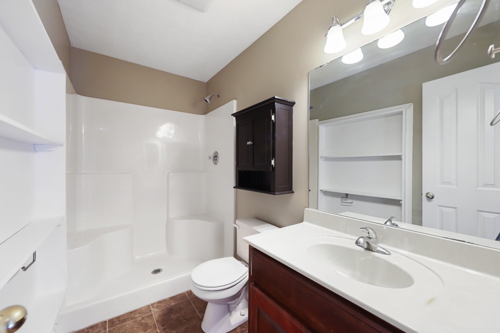323 Independence Street Springfield, TN 37172 - Photo 20 of 37 a bathroom with a sink toilet a mirror and shower