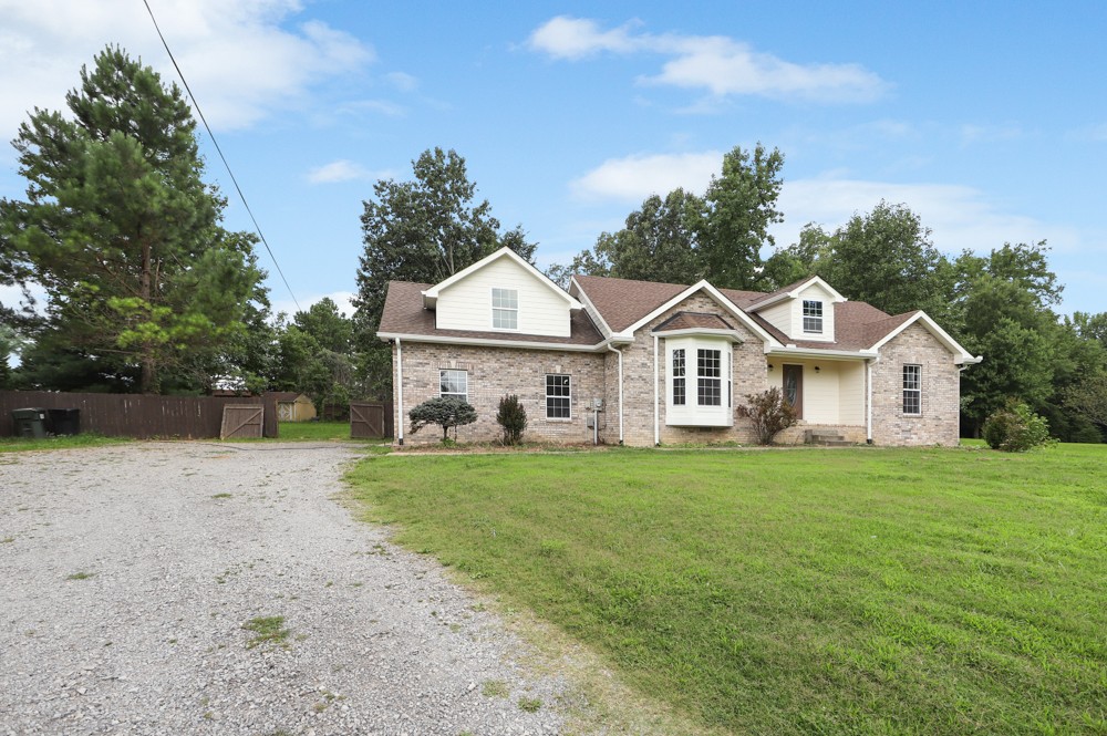 323 Independence Street Springfield, TN 37172 - Photo 2 of 37 a view of a yard in front of a house with large trees