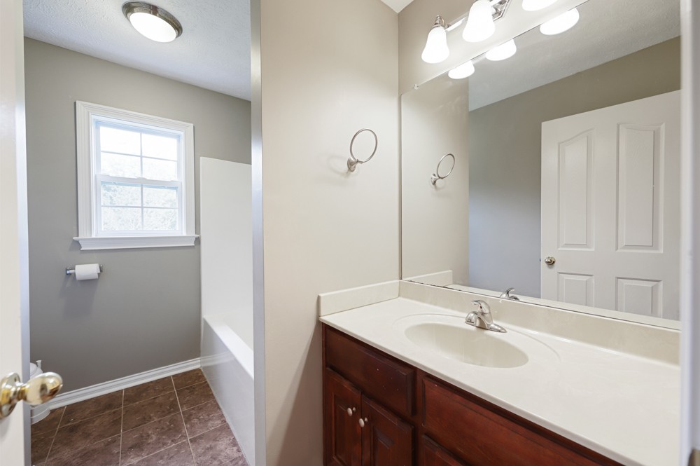 323 Independence Street Springfield, TN 37172 - Photo 23 of 37 a bathroom with a sink vanity granite and a mirror