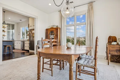 a living room with furniture a table and chairs
