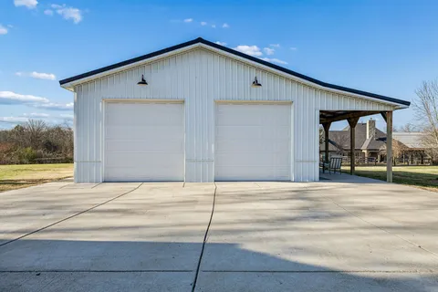 a view of a house with a swimming pool and a yard