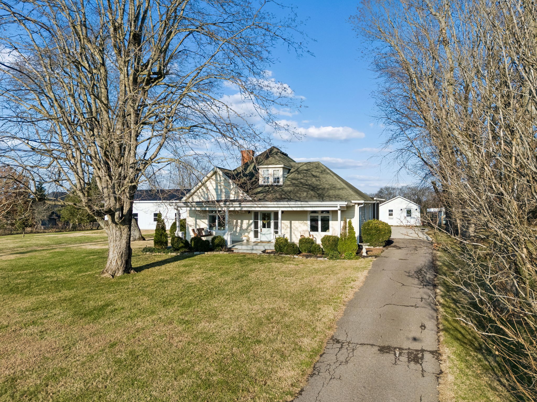 6320 Arno Road Franklin, TN 37064 - Photo 4 of 48 a view of a big house with a big yard and large trees