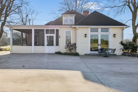 a house view with swimming pool in front of it