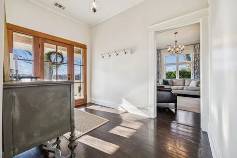a living room with furniture and large windows