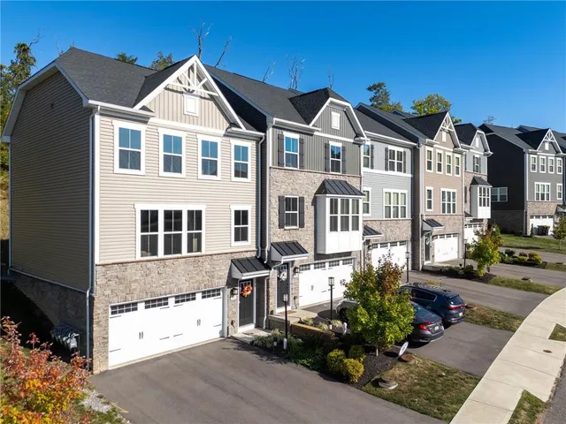a front view of a residential houses with yard