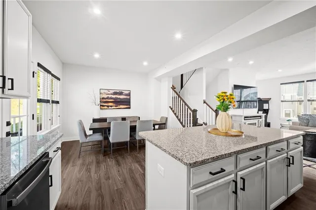 a kitchen with a table chairs and wooden floor