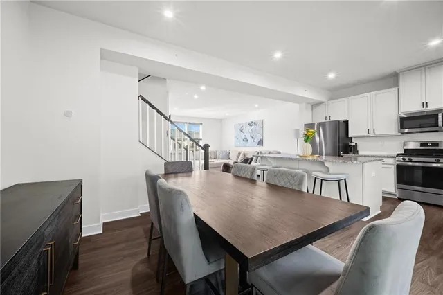 a view of a dining room with furniture and wooden floor