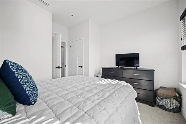 a bedroom with a bed and a television