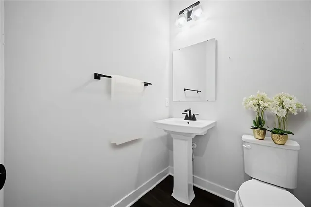 a bathroom with a sink toilet and a mirror