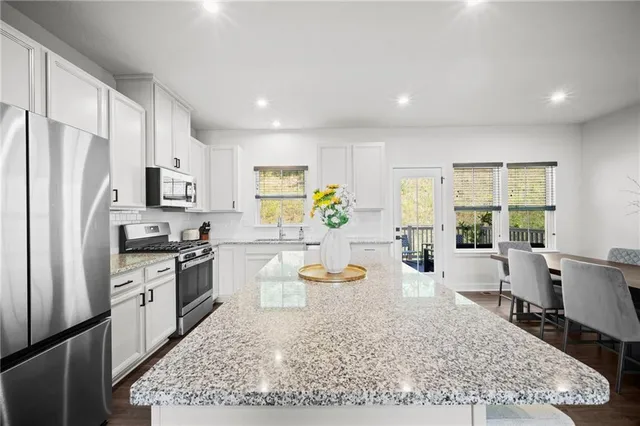 a kitchen with a refrigerator and wooden cabinets