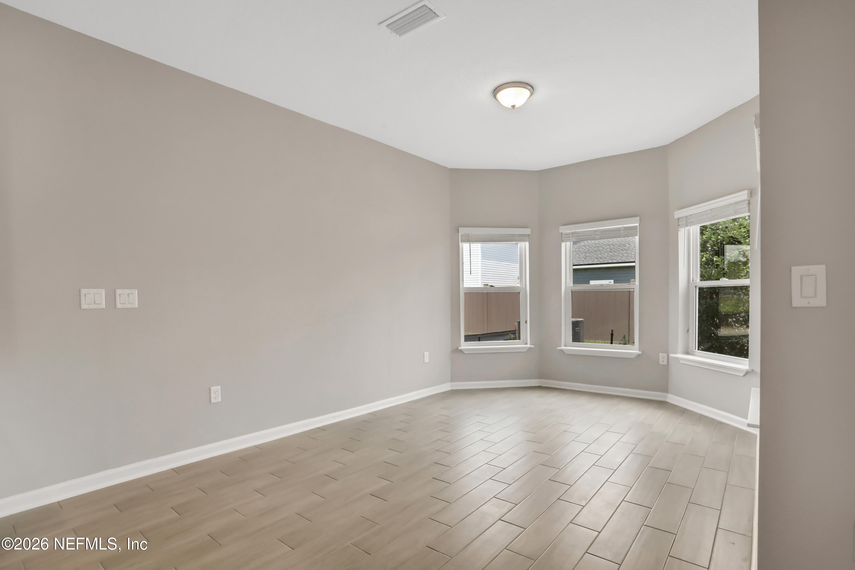 3157 Gadwall Road Orange Park, FL 32065 - Photo 11 of 36 wooden floor in an empty room with a window