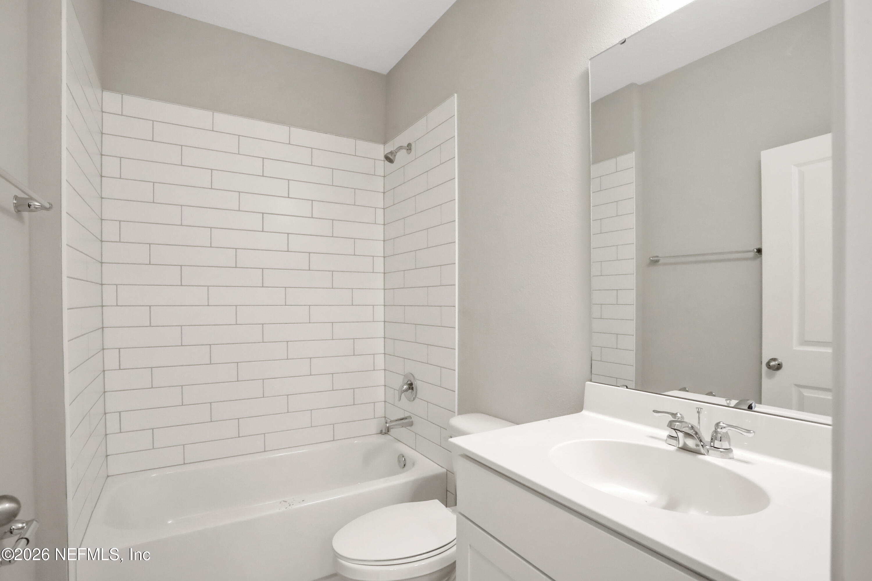 3157 Gadwall Road Orange Park, FL 32065 - Photo 19 of 36 a bathroom with a bathtub shower sink vanity mirror and toilet