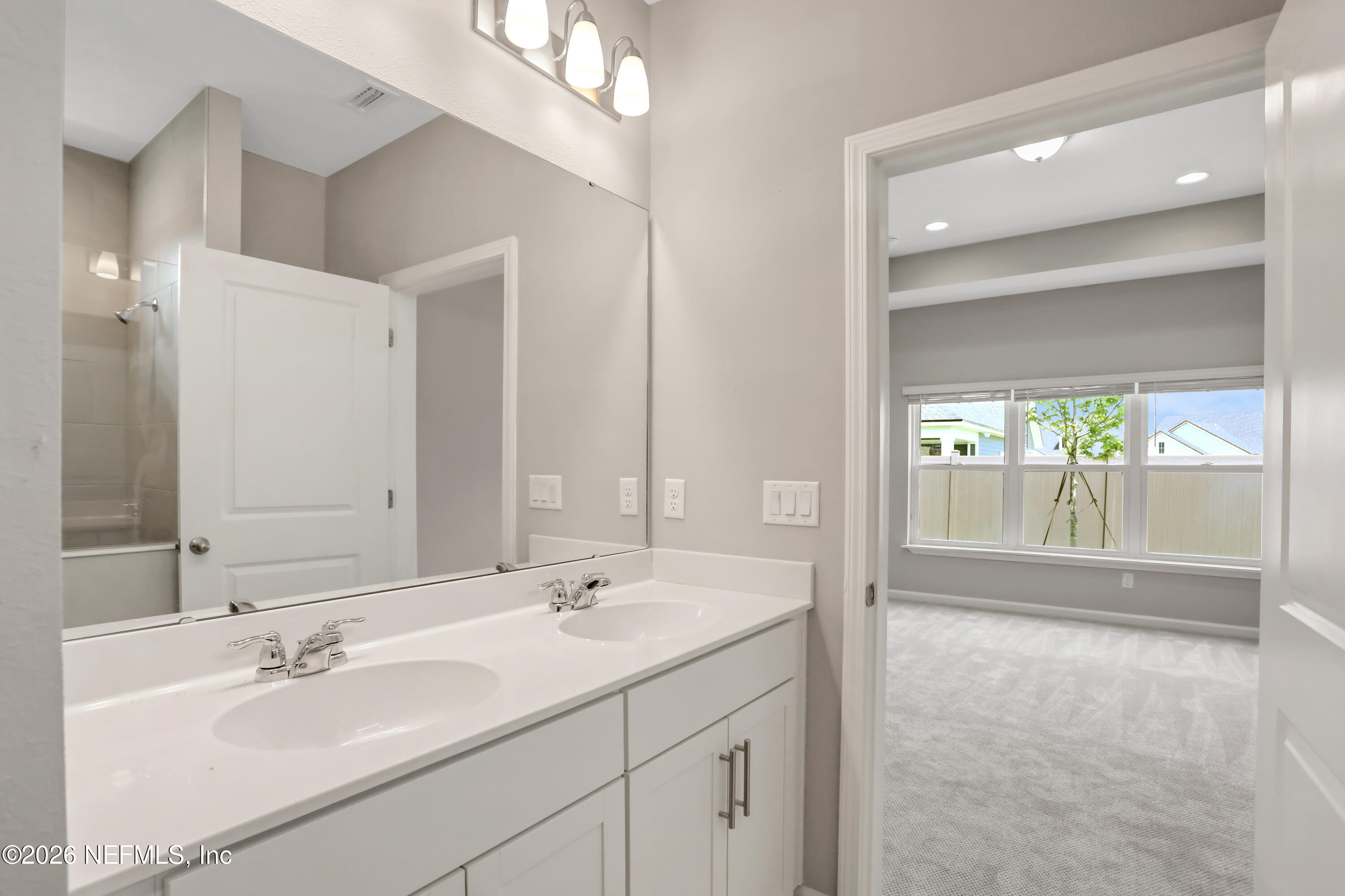 3157 Gadwall Road Orange Park, FL 32065 - Photo 28 of 36 a bathroom with a sink double vanity and a mirror