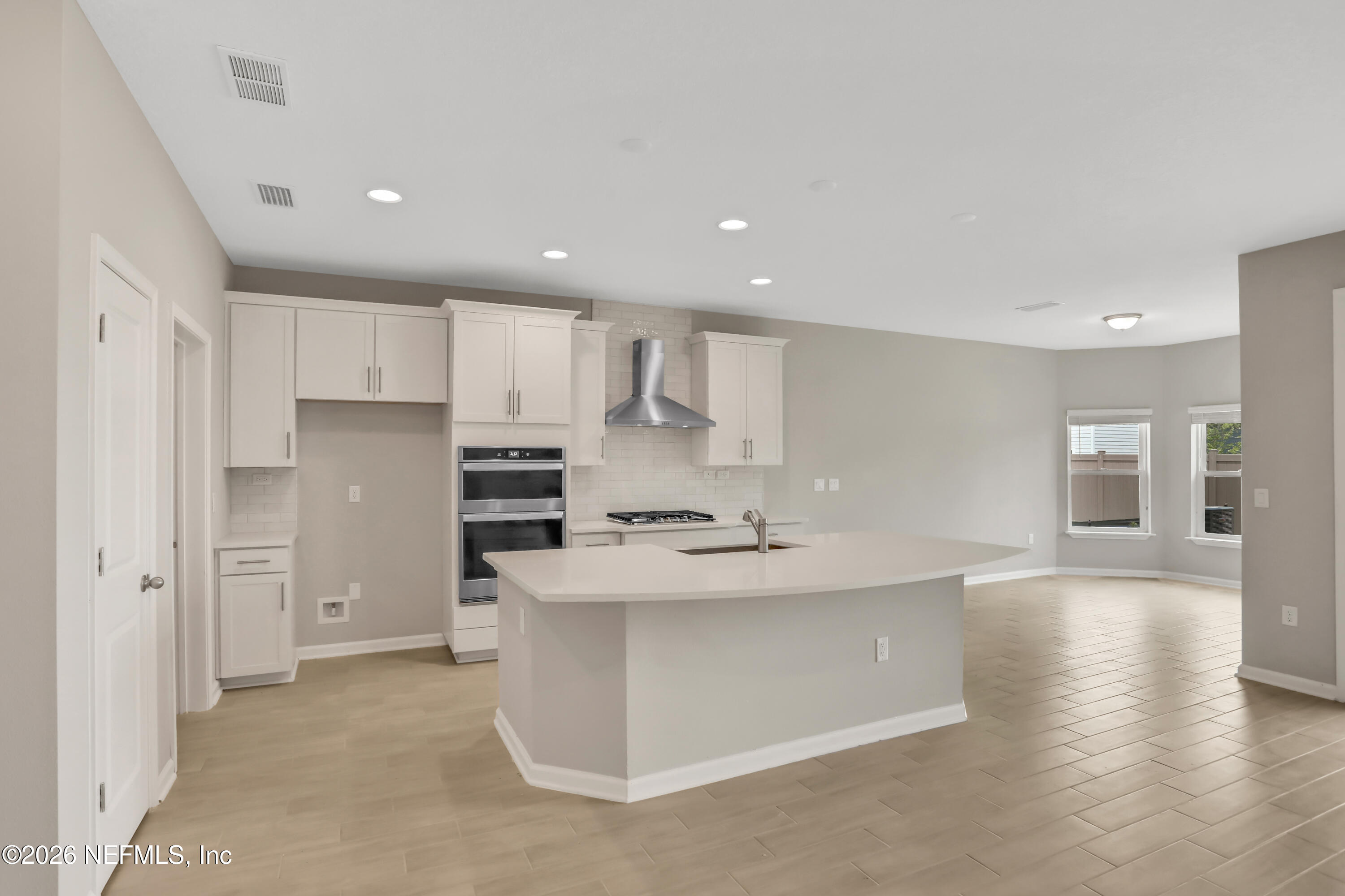 3157 Gadwall Road Orange Park, FL 32065 - Photo 3 of 36 a kitchen with stainless steel appliances granite countertop a refrigerator sink and white cabinets