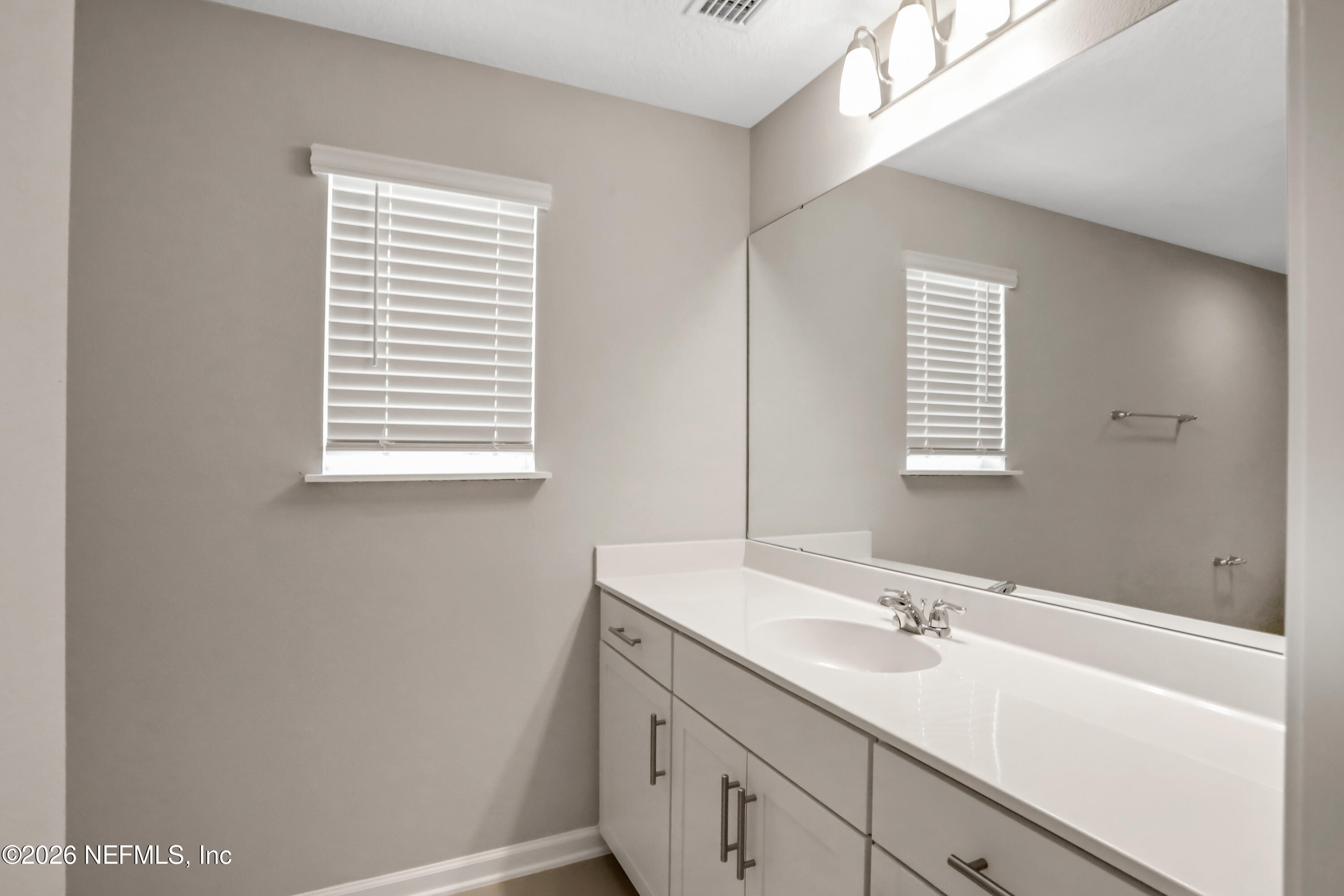 3157 Gadwall Road Orange Park, FL 32065 - Photo 33 of 36 a bathroom with a sink a vanity and a mirror