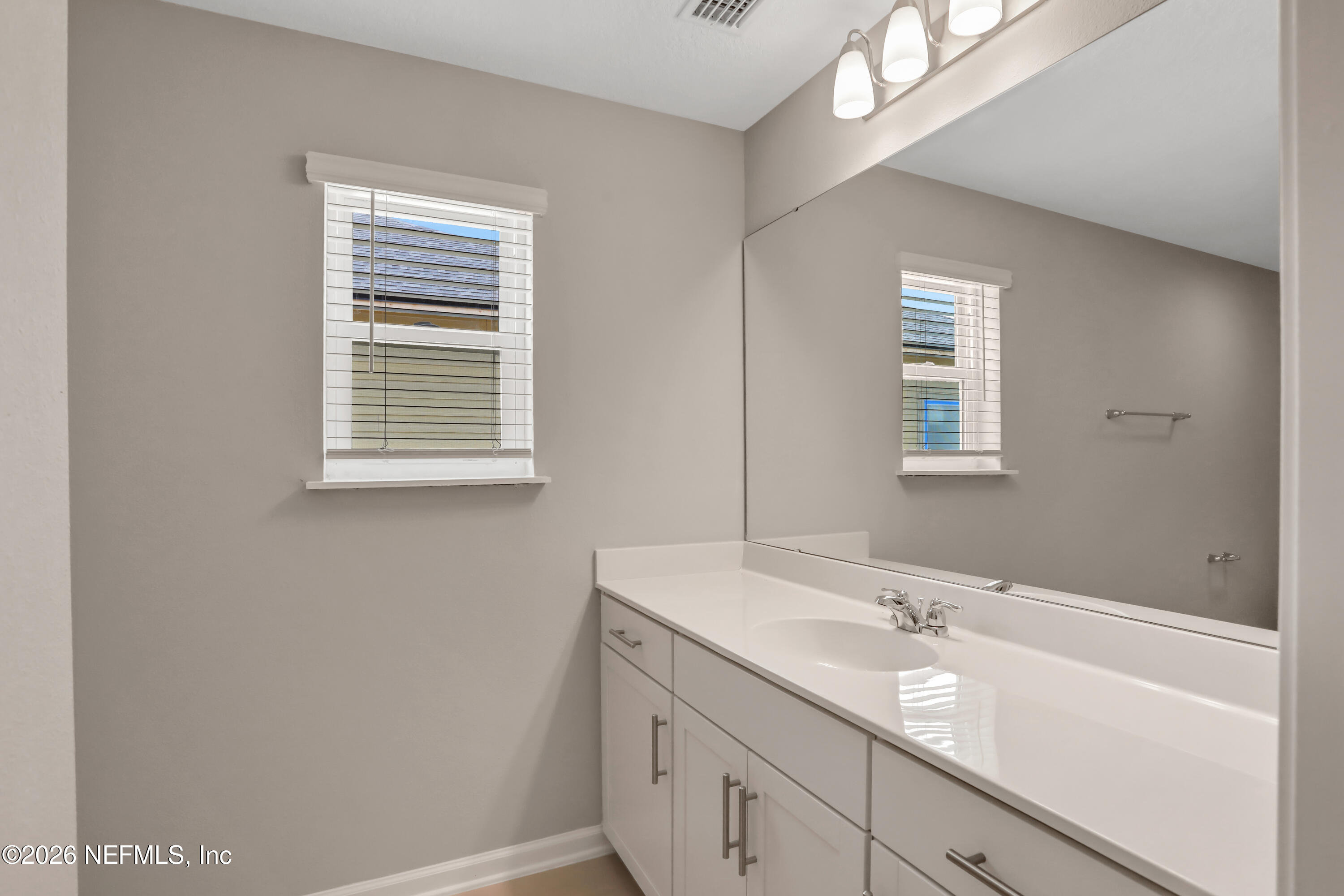 3157 Gadwall Road Orange Park, FL 32065 - Photo 34 of 36 a bathroom with a sink a vanity and a mirror