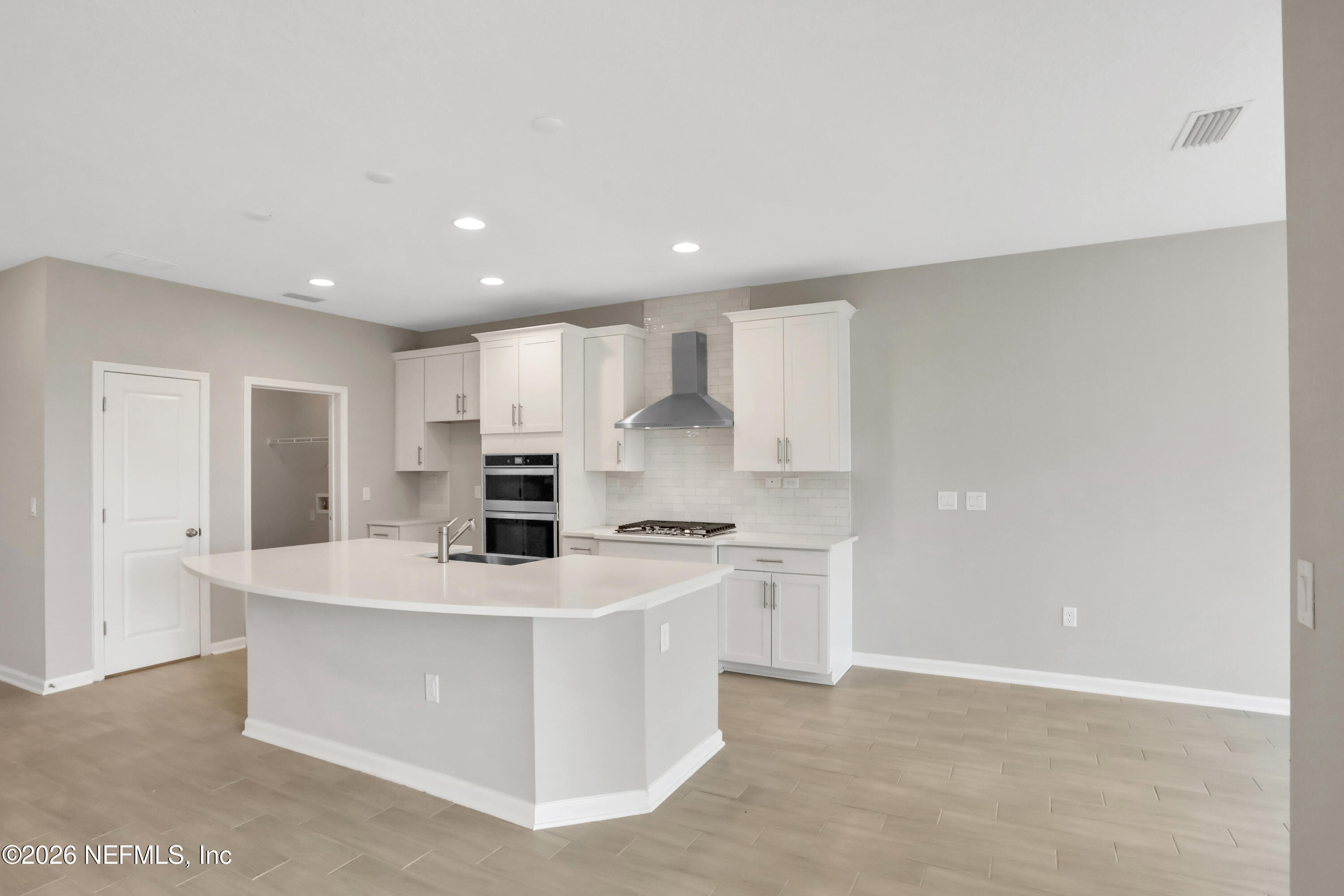3157 Gadwall Road Orange Park, FL 32065 - Photo 4 of 36 a kitchen with kitchen island a sink stainless steel appliances and white cabinets
