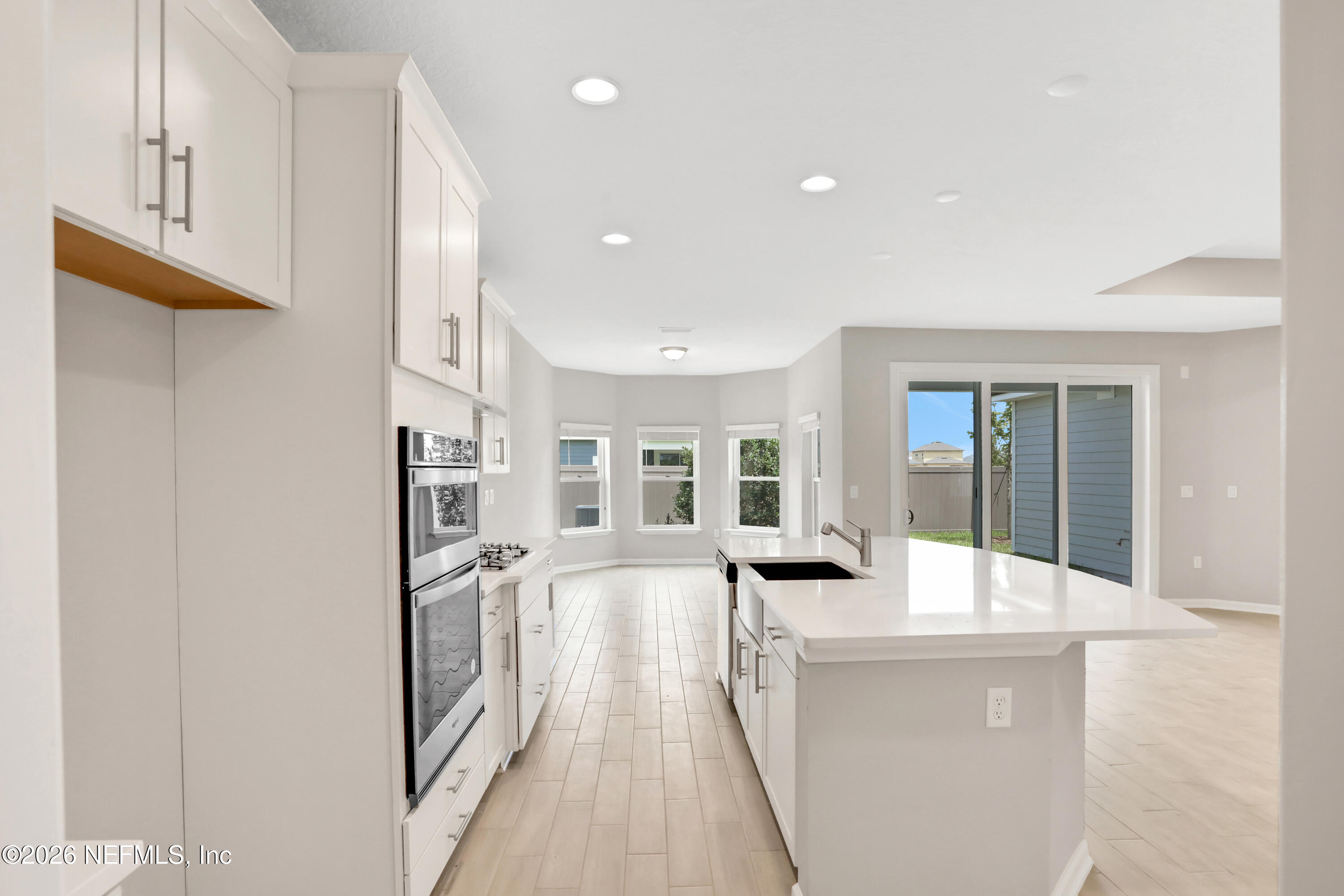 3157 Gadwall Road Orange Park, FL 32065 - Photo 7 of 36 a living room with stainless steel appliances furniture a flat screen tv and a window