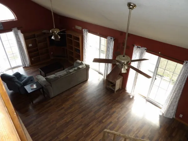 a view of a living room with furniture and a fireplace