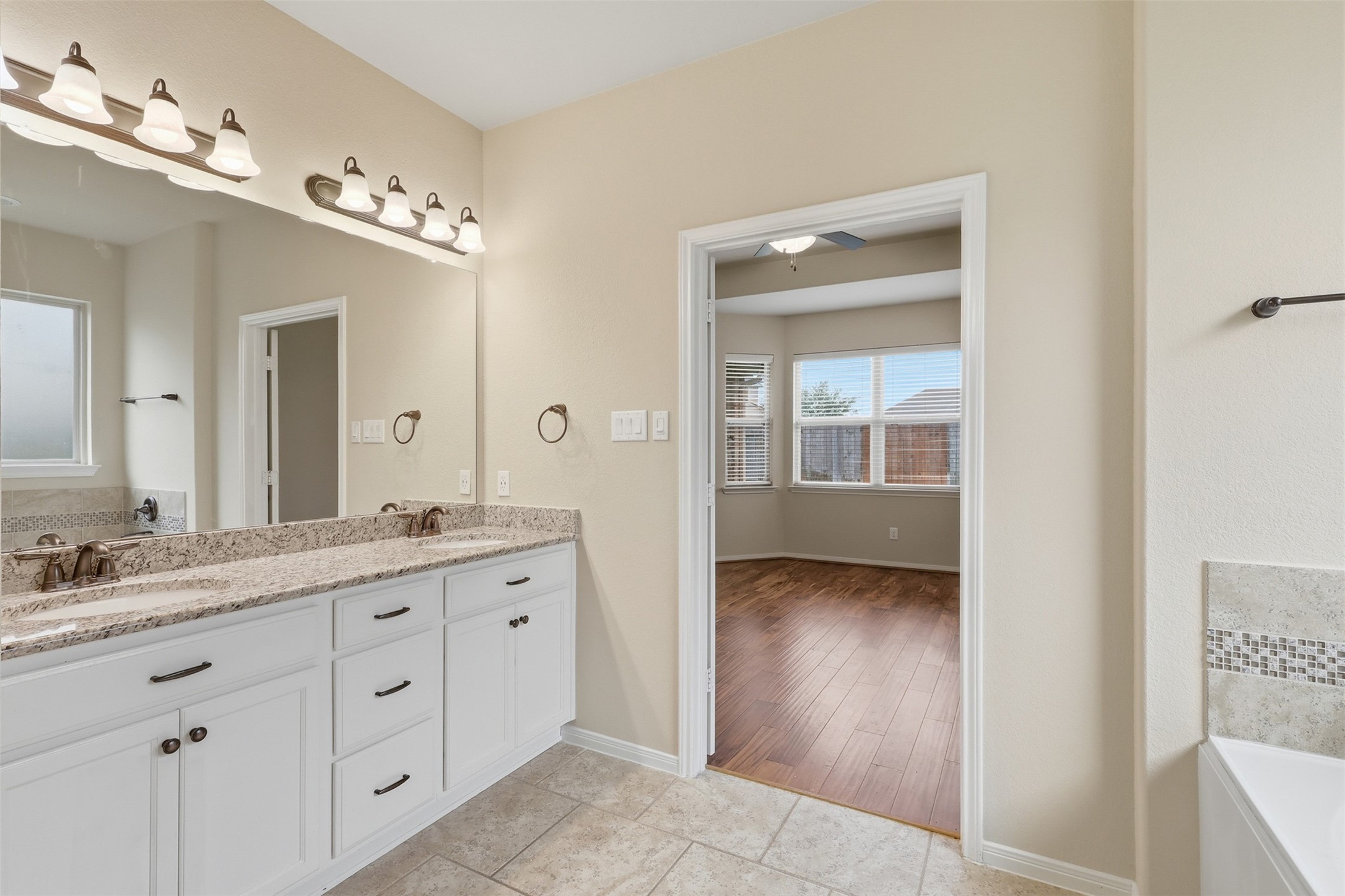 22943 Dale River Road Tomball, TX 77375 - Photo 18 of 29 a en suite bathroom with a granite countertop sink a mirror and a