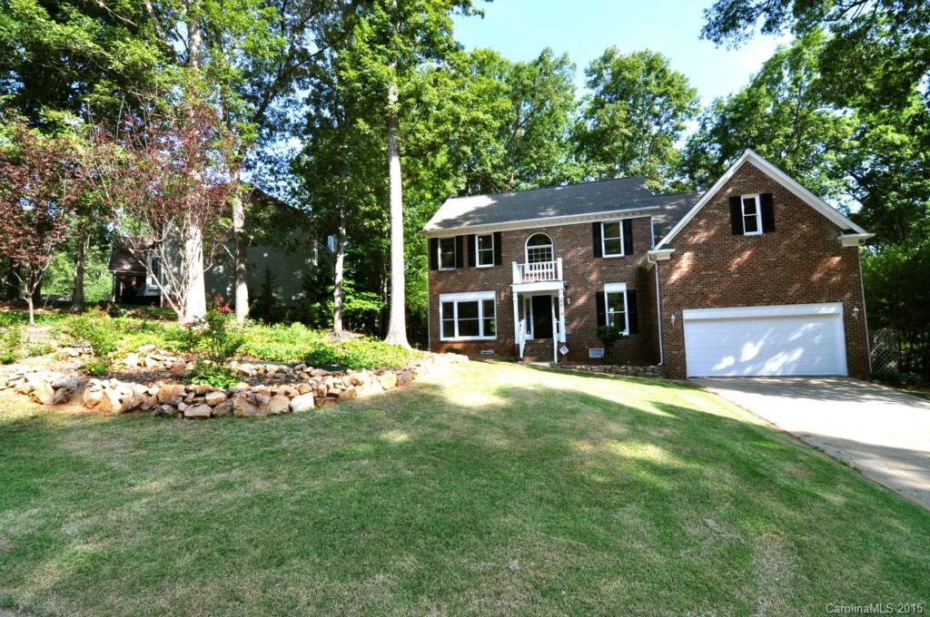 a front view of a house with a garden and yard