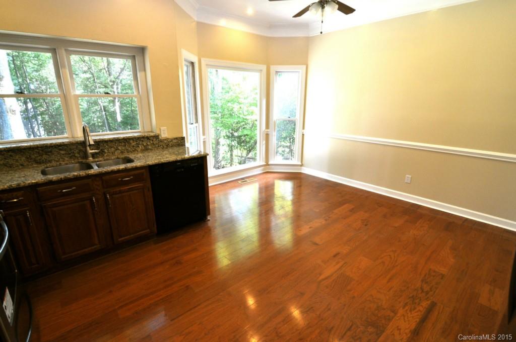 5015 Ridgetop Trail Charlotte, NC 28215 - Photo 13 of 24 a view of an empty room with a window and wooden floor