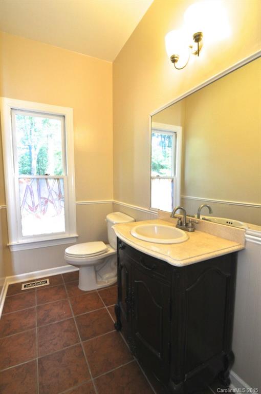 5015 Ridgetop Trail Charlotte, NC 28215 - Photo 14 of 24 a bathroom with a sink and a mirror